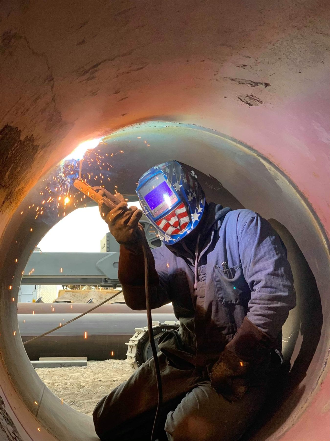 MIG welder laying a wire-feed bead on steel in the Treasure Valley, Idaho